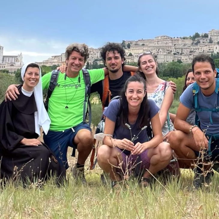 A Jesuits, a nun and a group of young women and men during a pilgrimage in Assisi, Italy